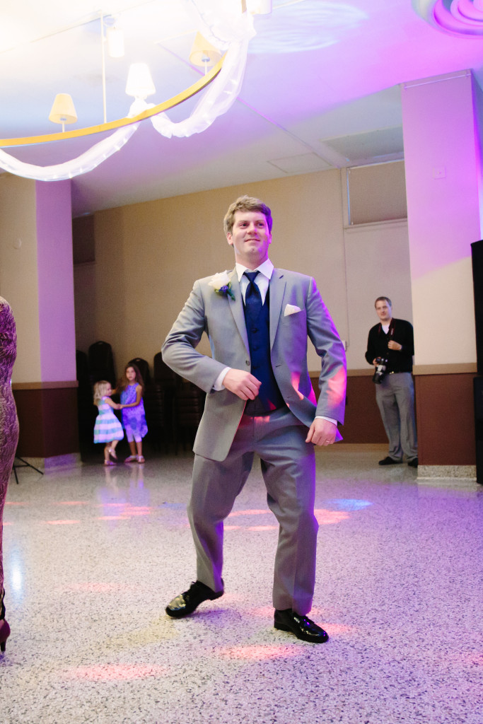 Groom dancing at reception in Masonic Ballroom in Eau Claire, Wisconsin