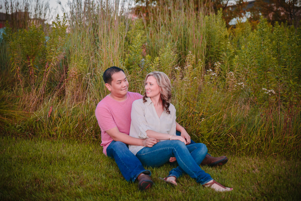 Married couple sitting together on ground in phoenix park eau claire