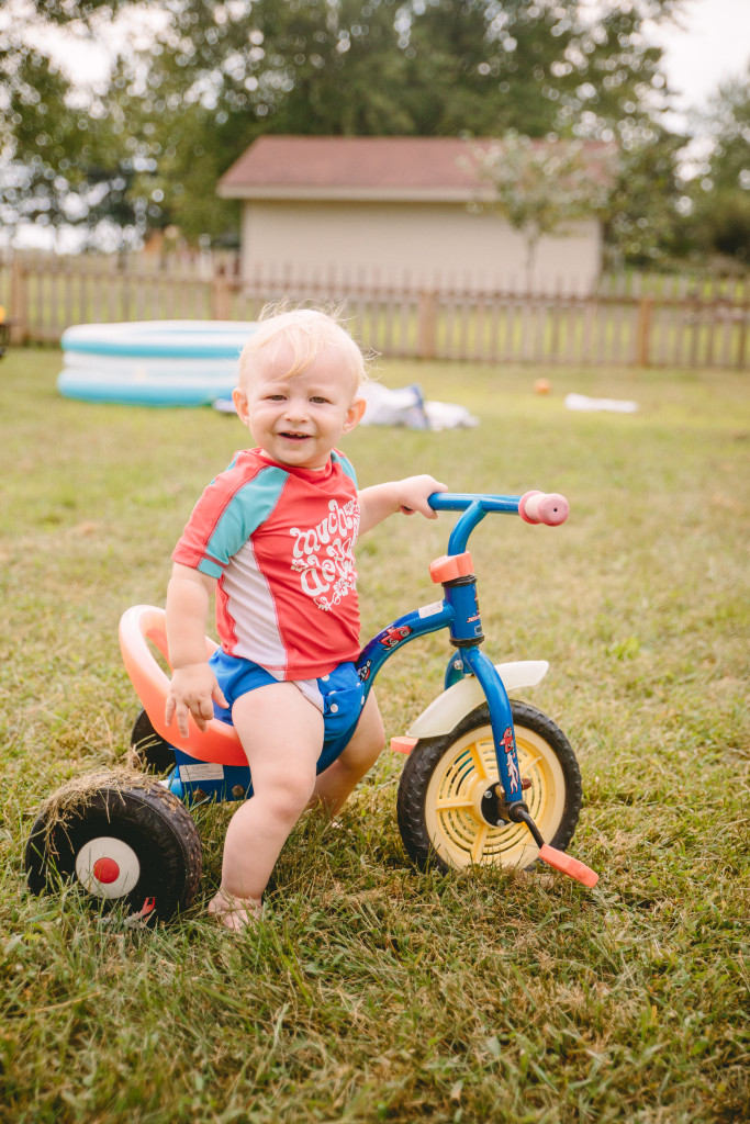 little boy on trike in his backyard