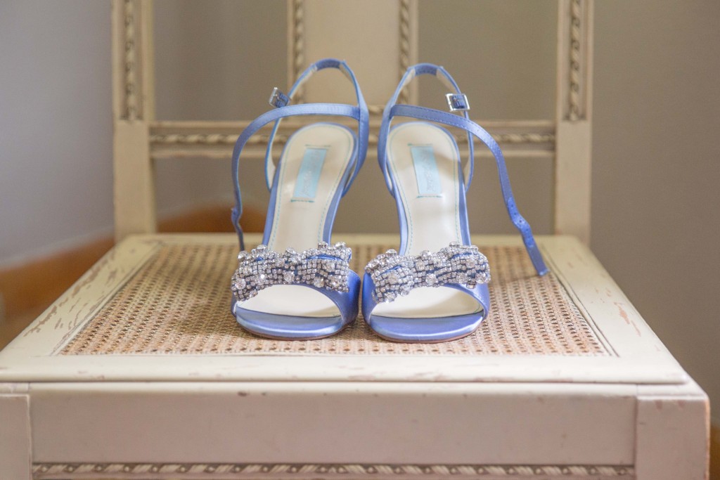 Bridal shoes sitting on a chair before getting ready by Alisha Marie Eau Claire Wedding Photographer