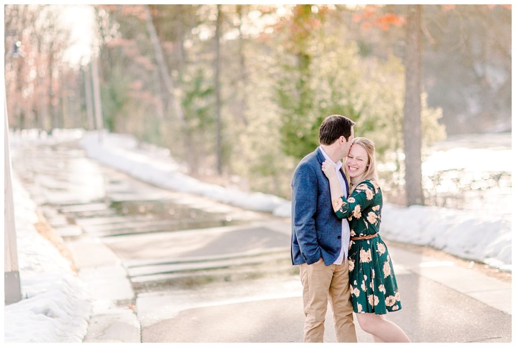 Early spring engagement session in River Prairie Altoona WI laughing together in the sunshine 