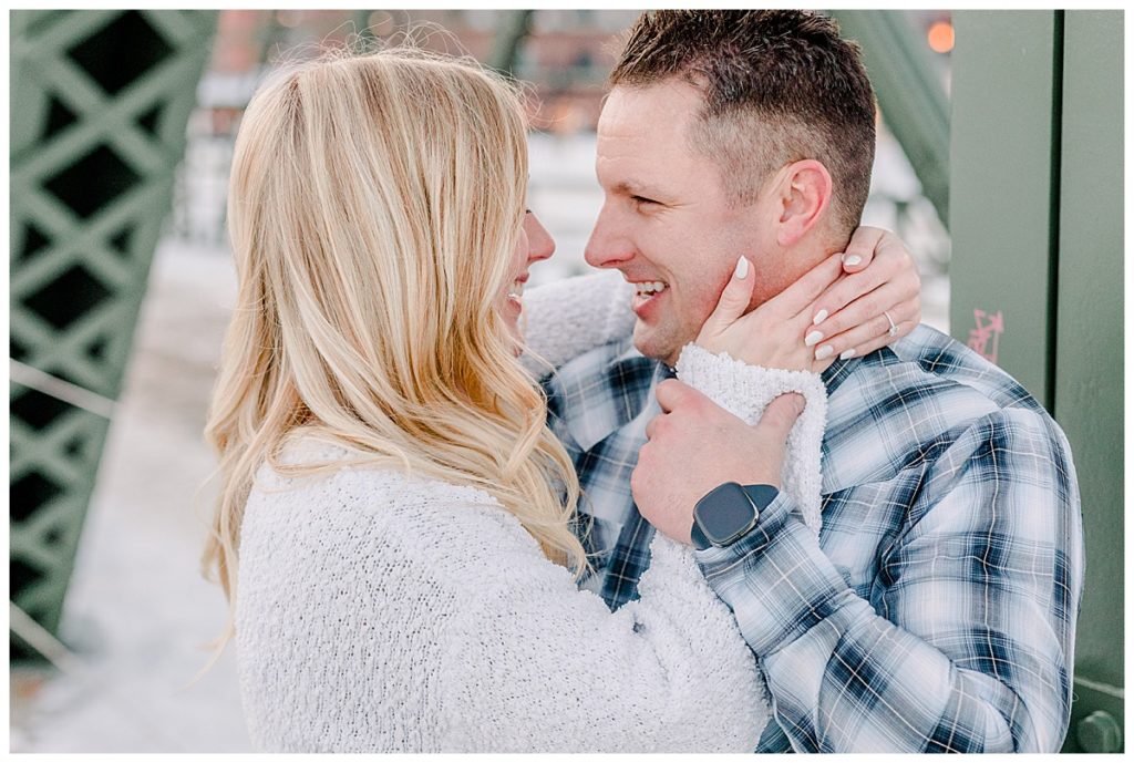 Couple shares a laugh in their downtown Stillwater minnesota engagement session, taken by Alisha Marie Photography from wisconsin, on the Stillwater lift bridge