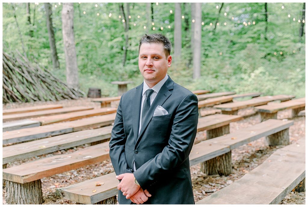Wedding at Fest Valley Events has a rock theme including a rock tail hour. Eau Claire Wedding Photographer Alisha Marie shoots wedding outside Cadott First look at the ceremony site before wedding day photography groom portrait