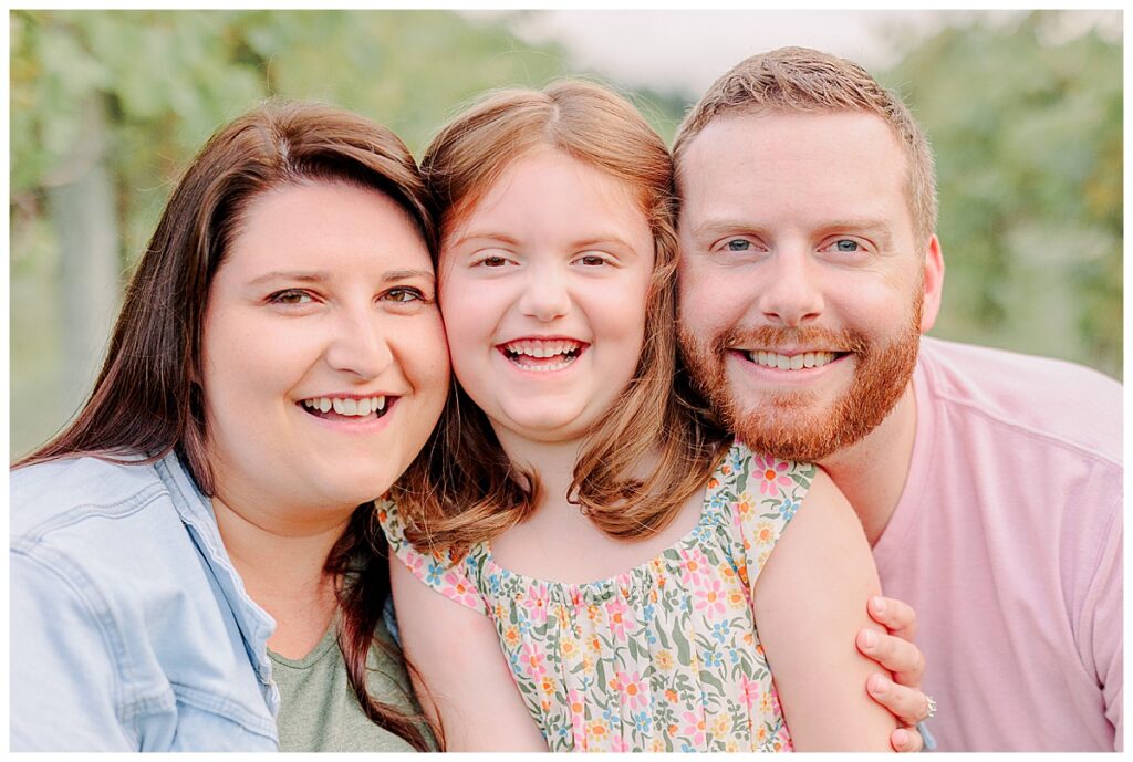 Close up of smiling familty family photography session at Riverbend Winery near Eau Claire Wisconsin Photo take by Alisha Marie Photography, Eau Claire Family Photographers; Family Photos Eau Claire