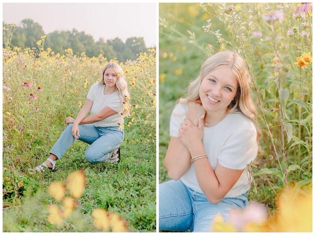 senior for the class of 2024 posing for her senior portraits outside of Eau Claire, Wisconsins. She sits in a field of wild flowers and wears a neutral soft colored sweatshirt