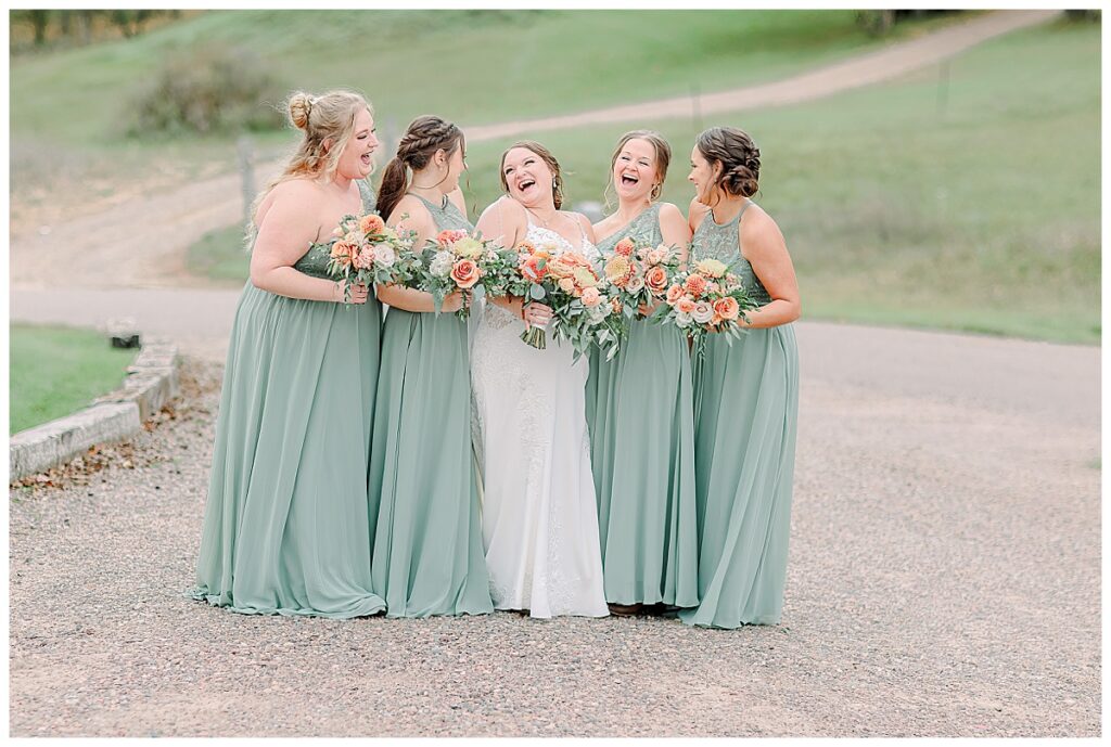 Wedding day wedding party portrait. Bridesmaids are laughing together. Image by Alisha Marie Photography at the wedding venue alluring acres not far from Minneapolis, Minnesota and St. Paul