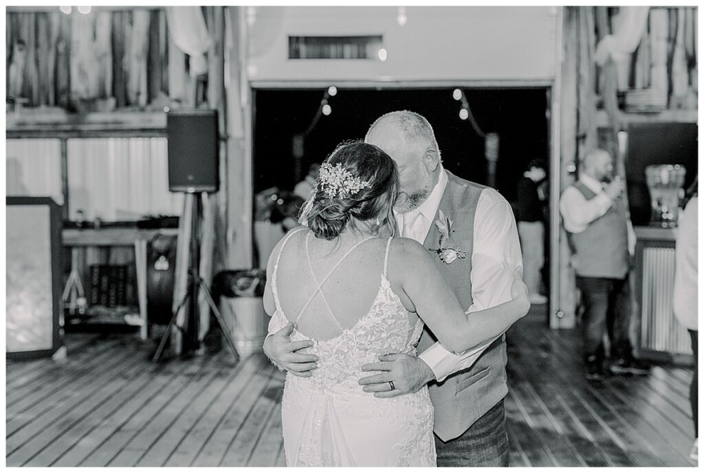 Bride and groom share their first wedding dance and pose for the photographer at the wedding venue alluring acres near Chippewa Falls Wisconsin