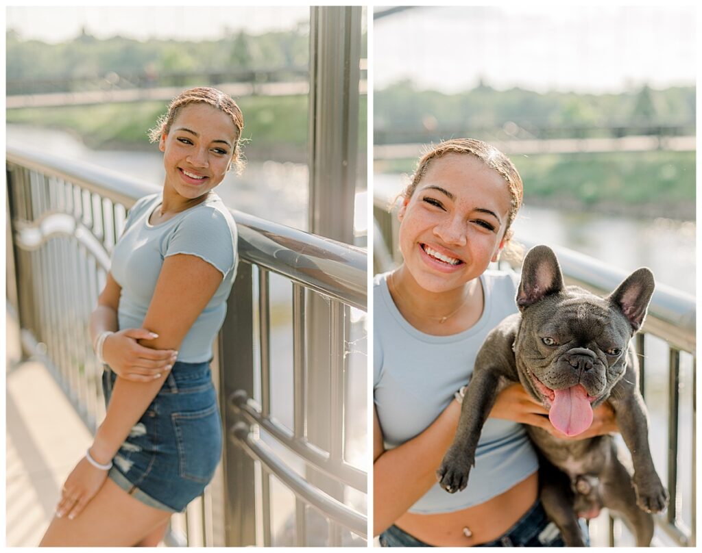Downtown Eau Claire Senior Portraits taken at on Barstow street in Wisconsin with a white wall behind the senior in her portraits she poses with her adorable French bulldog