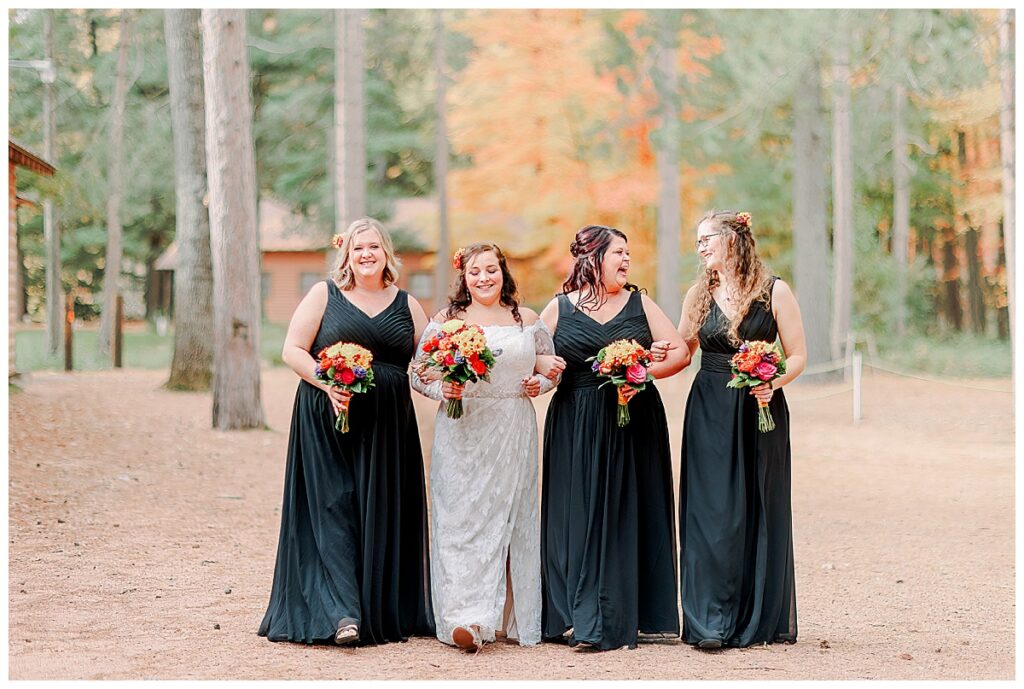 Lake Wissota Fall wedding photography taken by Alisha Marie Photography wedding day, bride with her bridesmaids dress in black gowns