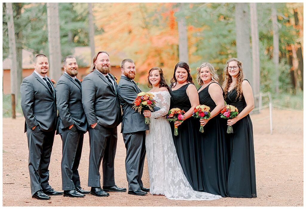 Lake Wissota Fall wedding photography taken by Alisha Marie Photography wedding day, bride with her bridesmaids dress in black gowns