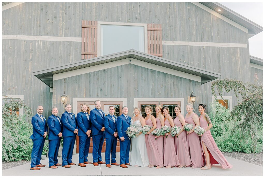 Wedding Party poses for a portrait outside the front of their wedding venue in Eau Claire photography, Lillydale