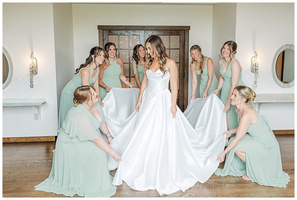 bridesmaids fluffing the brides dress photo taken at Lilydale- wisconsin wedding venue, Photography by Alisha Marie Photography